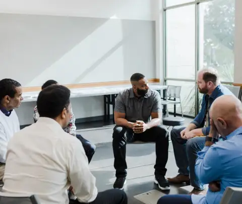 Group of men discuss challenging issues