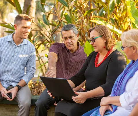 Group of people looks at computer