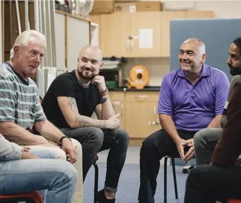 Group of men in support session