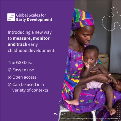 A mother holds a baby while reading about early childhood development tools in a bright room.