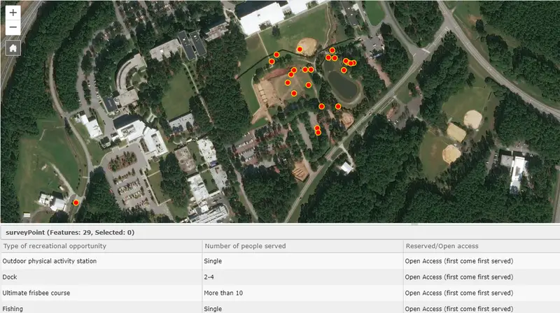 Aerial view showing recreational facilities, including a pond, fields, and forested areas.